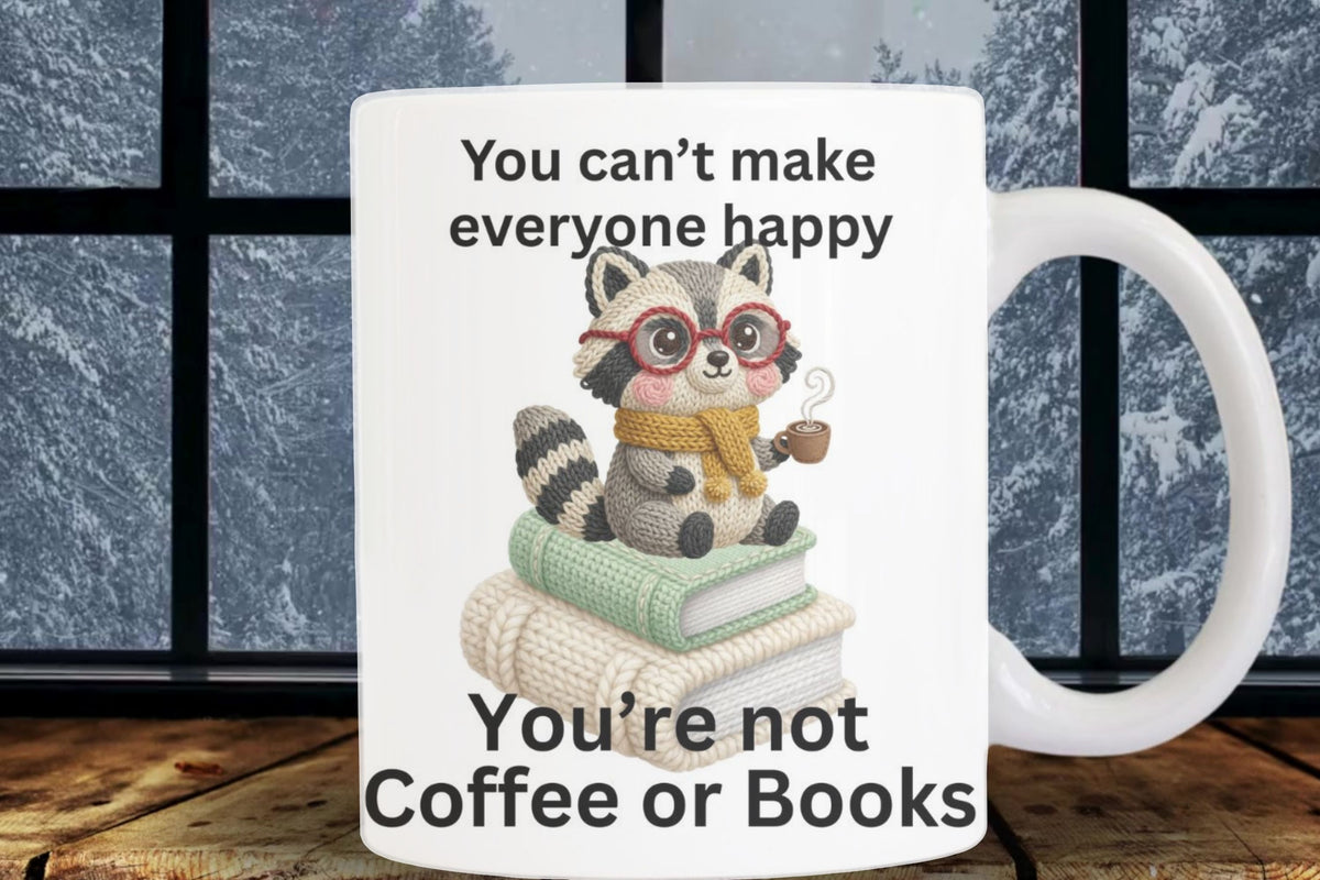 Mug with a raccoon illustration and text on a wooden surface with a window background
