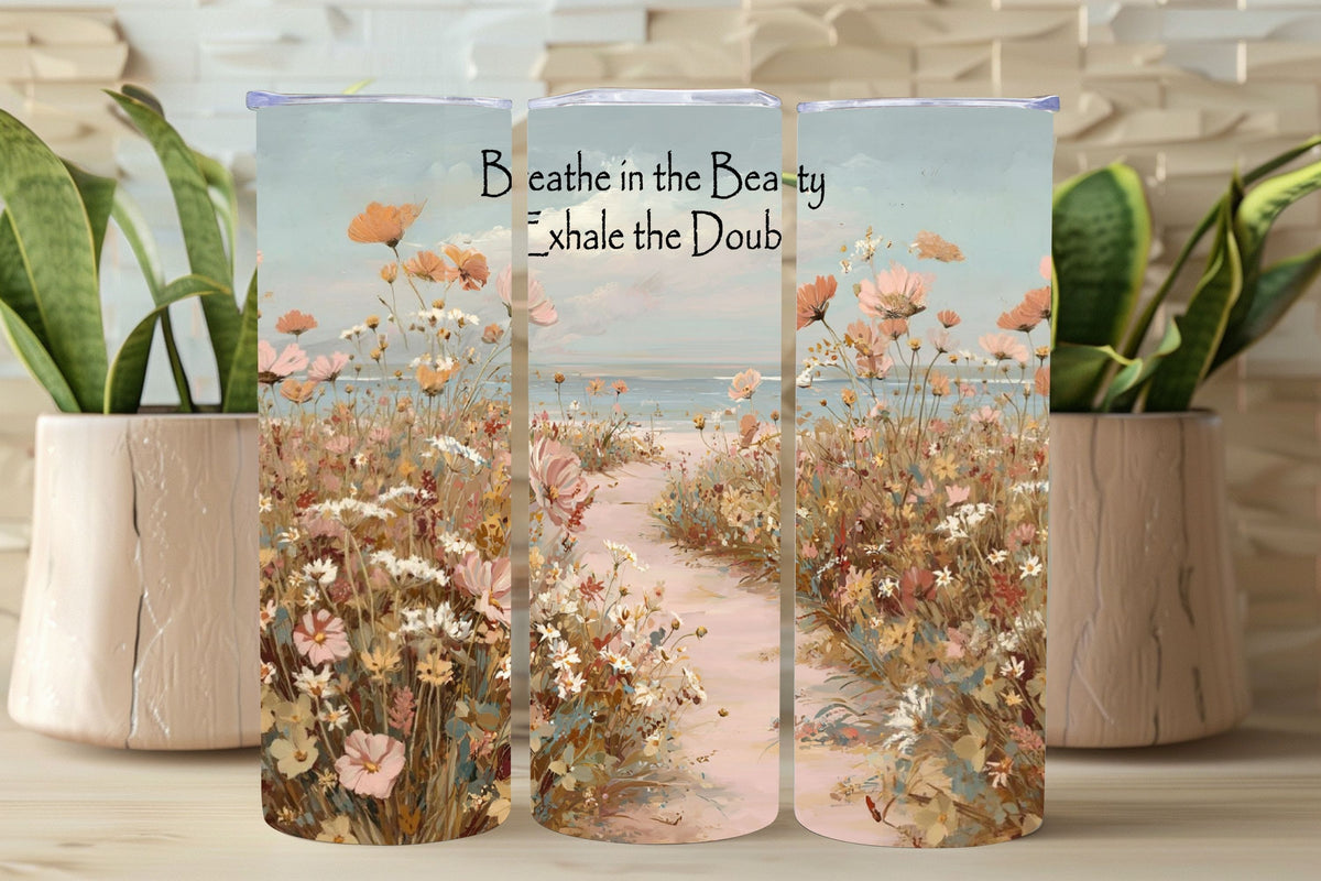 Three-tired decorative item with floral design and motivational text, placed on a wooden surface with plants.