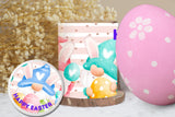 Decorative Easter items including a pink egg with white flowers, a small lamp with a gnome design, and a 'Happy Easter' coaster.