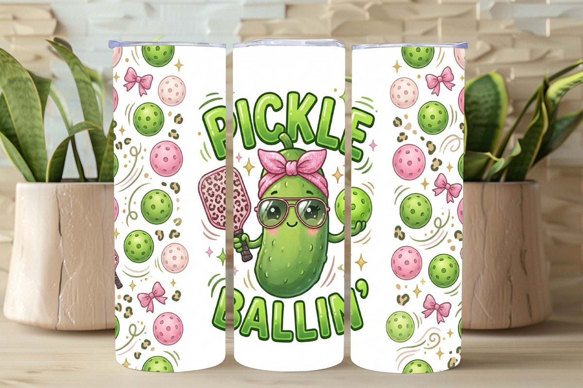 Three tumblers with pickle-themed designs on a wooden surface.