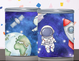 Two cylindrical containers with space-themed designs featuring an astronaut, Earth, and a rocket.