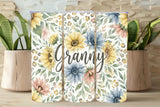 Floral design with the word 'Granny' on a wooden surface with plants in the background