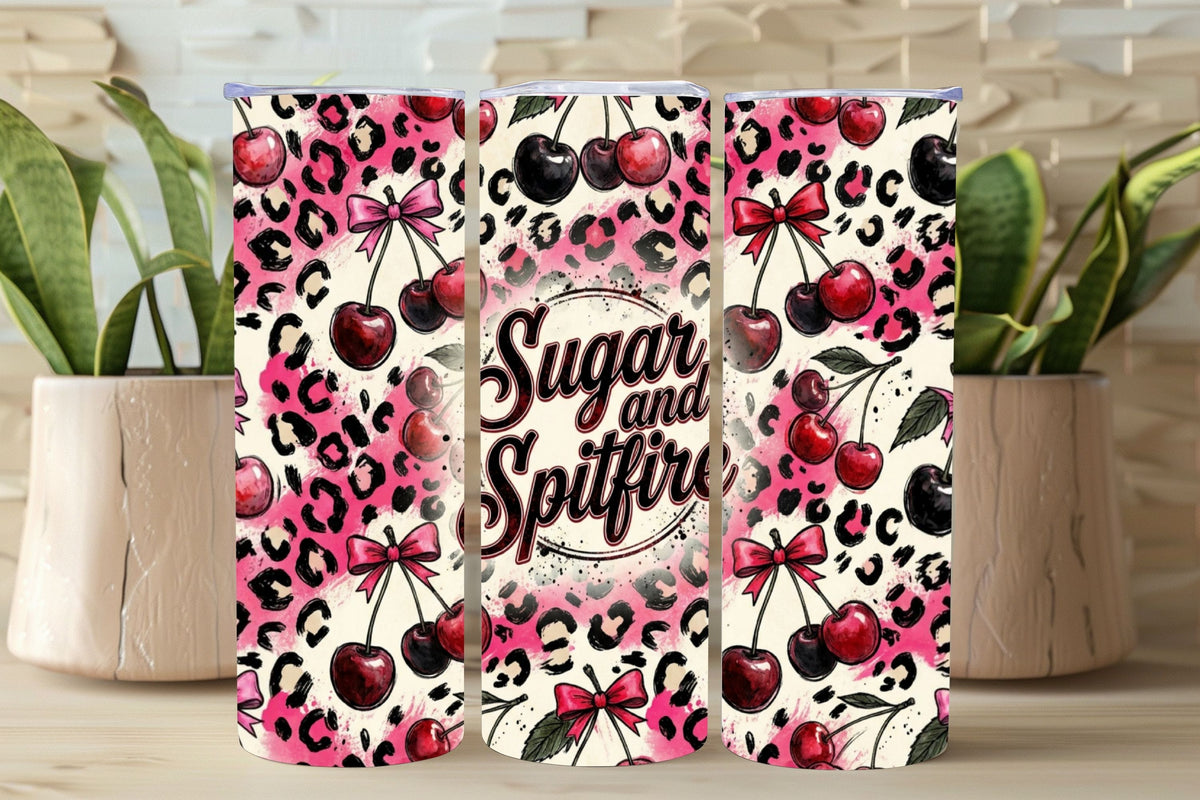 Three tumblers with cherry and leopard print design on a wooden surface.