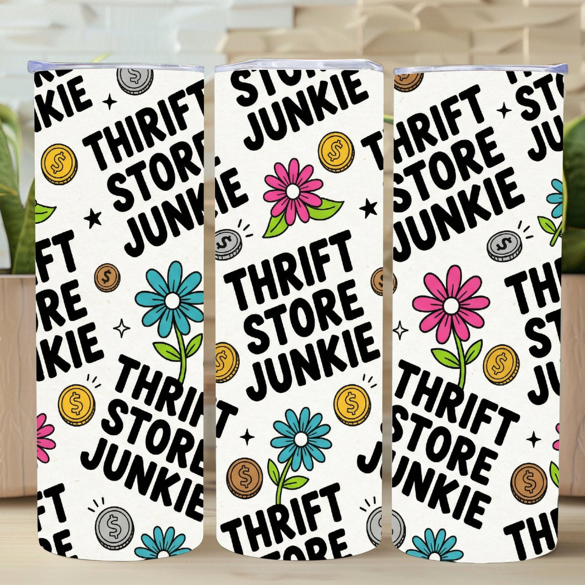 Three phone cases with 'Thrift Store Junkie' design on a wooden surface with plants in the background.