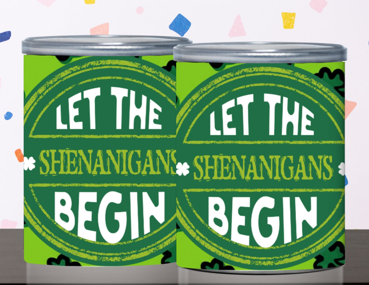 Two green cans with 'Let the Shenanigans Begin' text on a colorful background