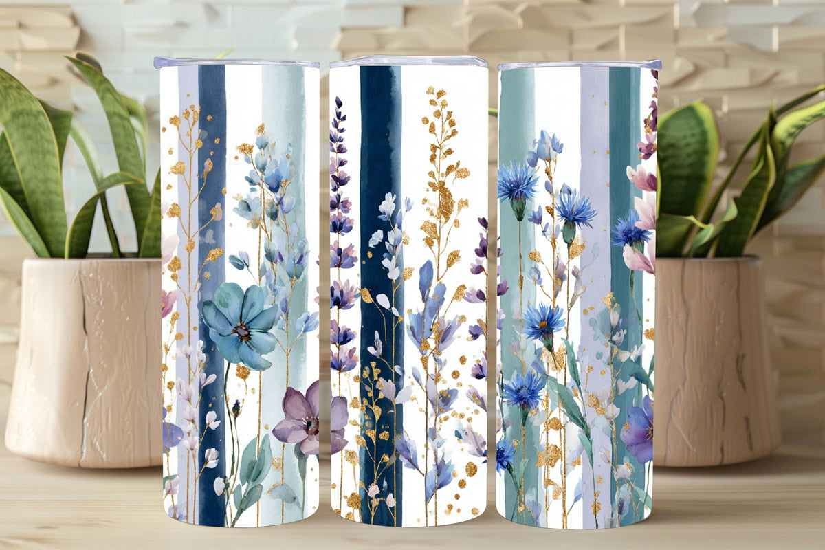 Three cylindrical containers with floral pattern on a wooden surface with plants in the background