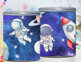 Two cylindrical containers with space-themed designs featuring astronauts and a rocket ship on a colorful background.