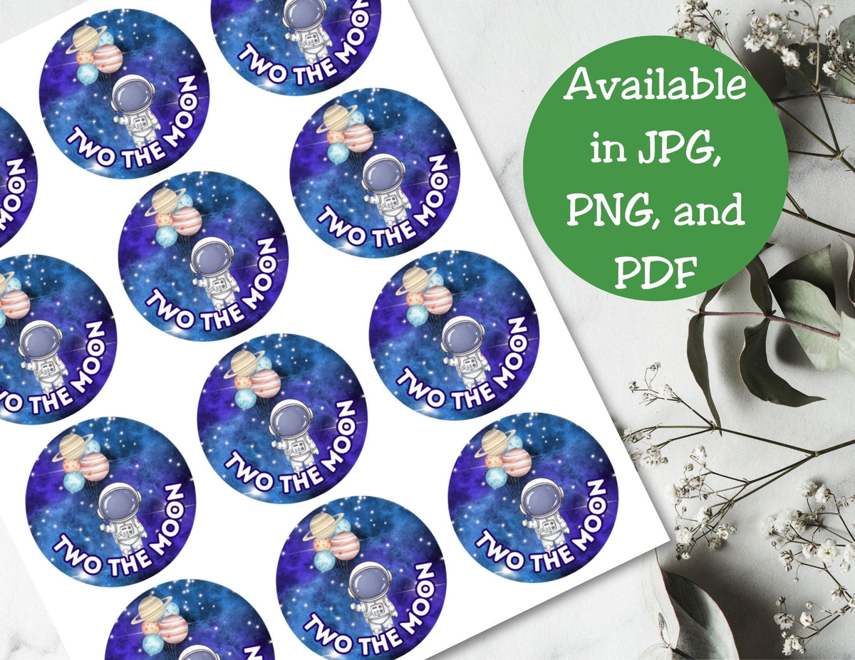 Stickers with 'Two the Moon' branding on a white surface with green text overlay.