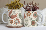 Two mugs with floral designs and motivational phrases, each containing dried flowers.