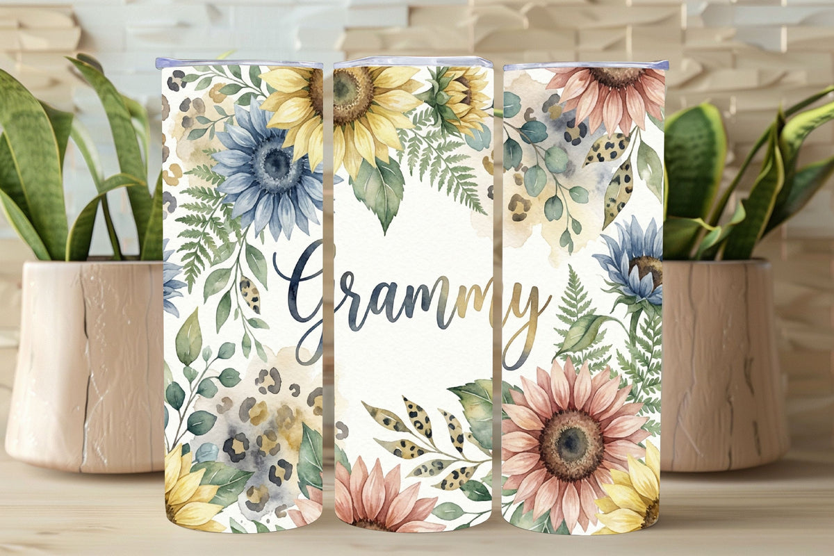 Three floral tumblers with 'Grammy' text on a wooden surface with plants.