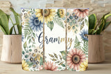 Three floral tumblers with 'Grammy' text on a wooden surface with plants.
