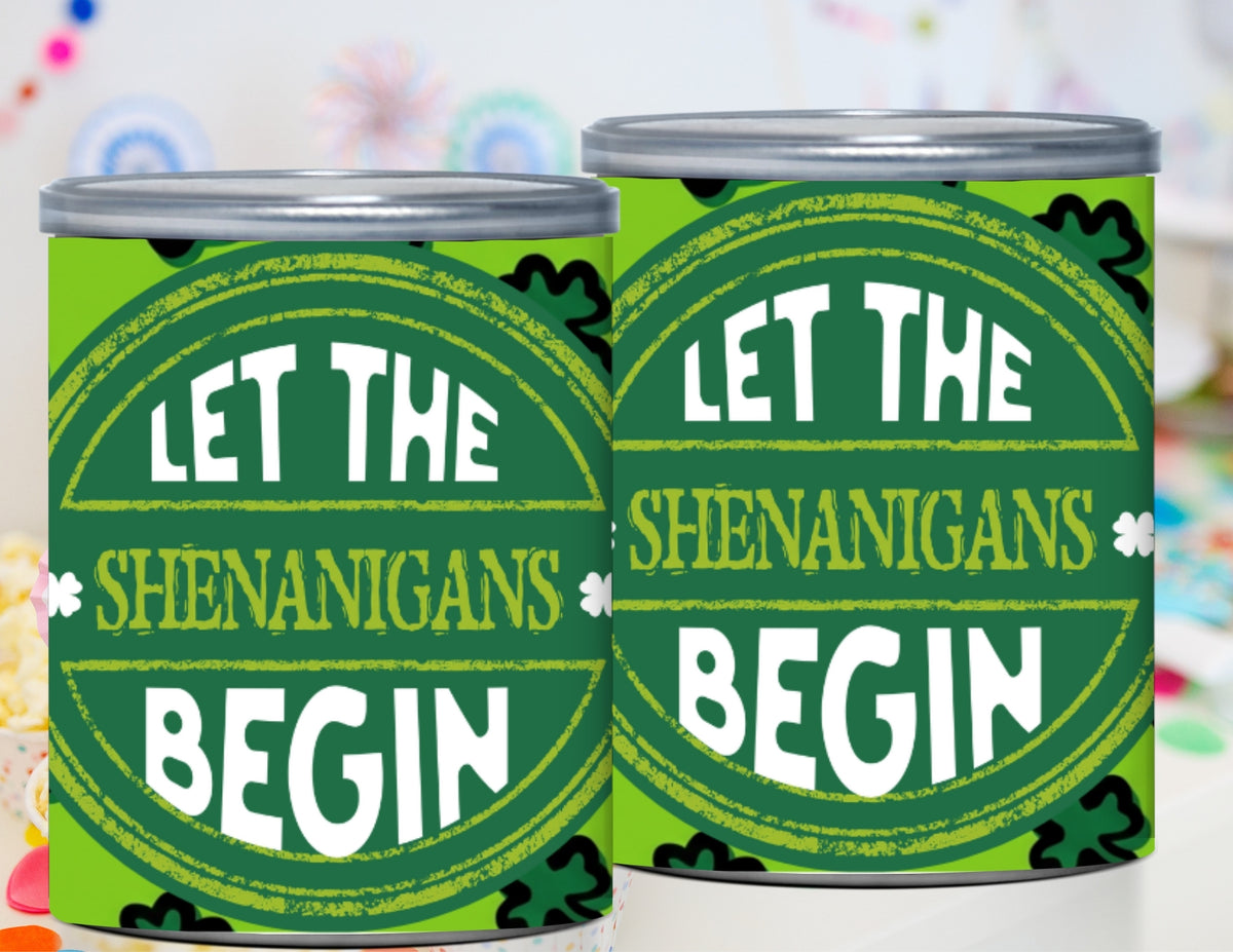 Two green cans with 'Let the Shenanigans Begin' text on a colorful background