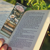 Floral bookmark on an open book with a blurred natural background