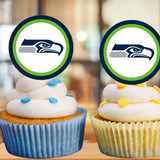 Two cupcakes with white frosting and blue and yellow decorations, topped with Seahawks logos.