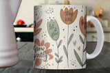 Mug with floral design and motivational phrases on a wooden surface