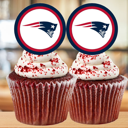 Two cupcakes with red velvet cake and white frosting, topped with New England Patriots logo, on a blurred background.