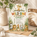 A jungle-themed children's first birthday invitation card displayed on a kraft envelope on a light wooden surface. The card features illustrated animals including a giraffe, zebra, lion, elephant, and cheetah, surrounded by tropical leaves and gold accents, with the text 'Our Wild One Is Turning One!'.