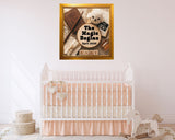 Nursery room with a crib, teddy bear, and decorative wall art.