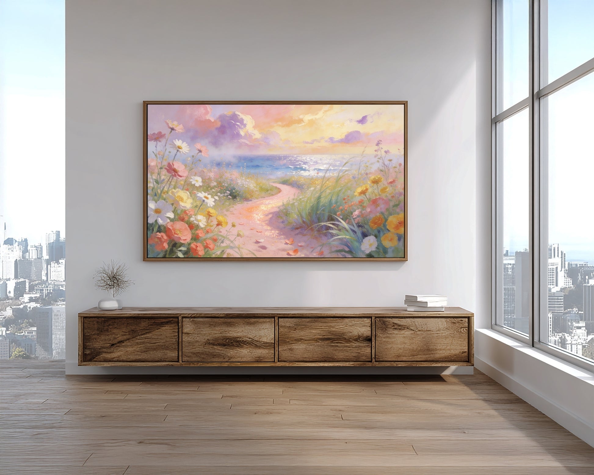 Framed artwork of a floral landscape on a wall above a wooden console table with cityscape view.