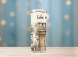 Tumbler with a scenic design and 'take me' text on a blurred background