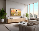 Modern living room with a large TV displaying an image of a man and a lamb in a field, with city skyline view.