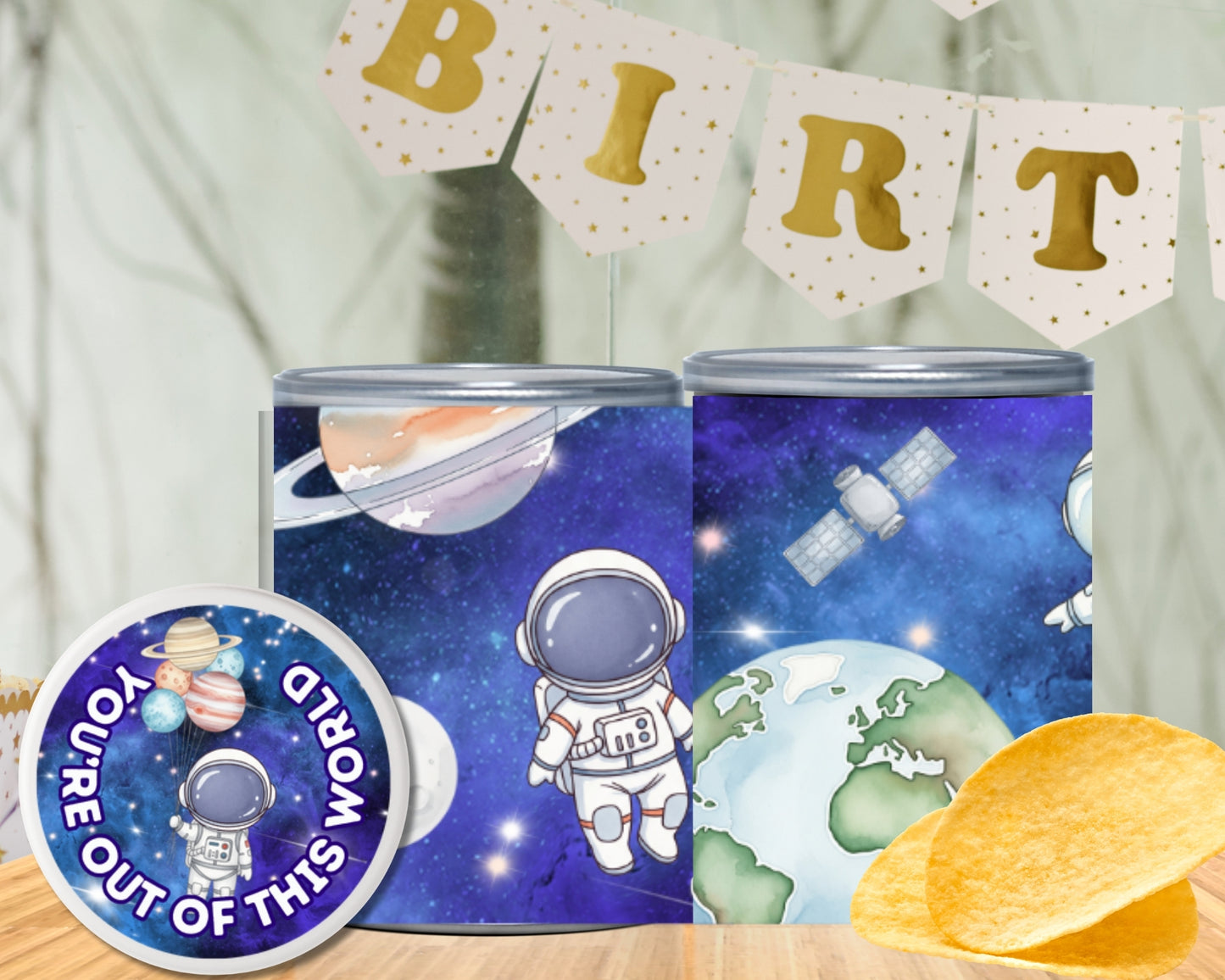 Two space-themed tins with an astronaut design, a 'You're Out of This World' sticker, and a 'Birthday' banner in the background.