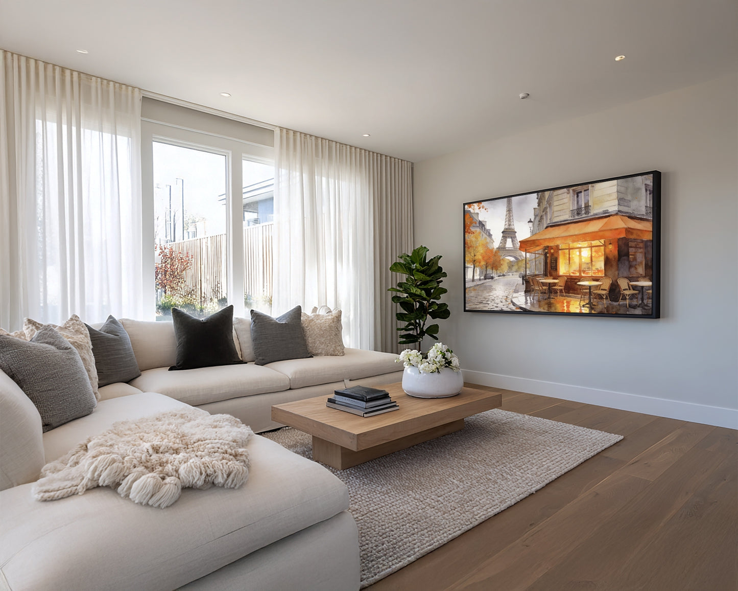 Modern living room with a sofa, coffee table, and TV displaying an image of a building.