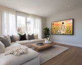 Modern living room with a large TV displaying a religious scene, beige sofa, and wooden coffee table.