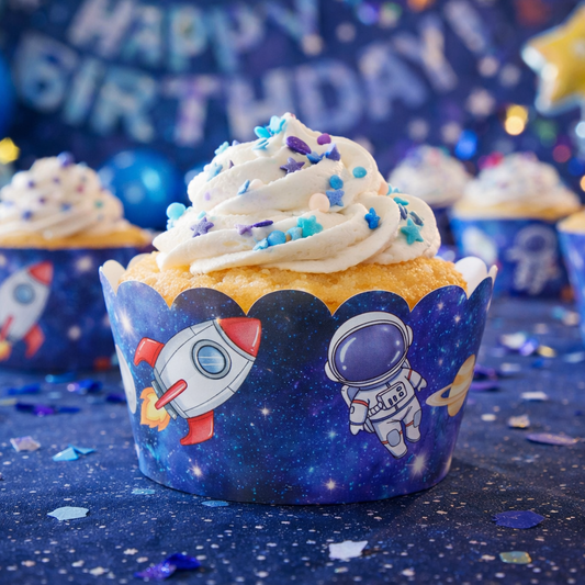 Cupcakes with space-themed wrappers on a dark blue background with confetti