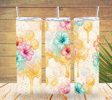 Three tumbler designs with floral and honeycomb patterns on a wooden background.