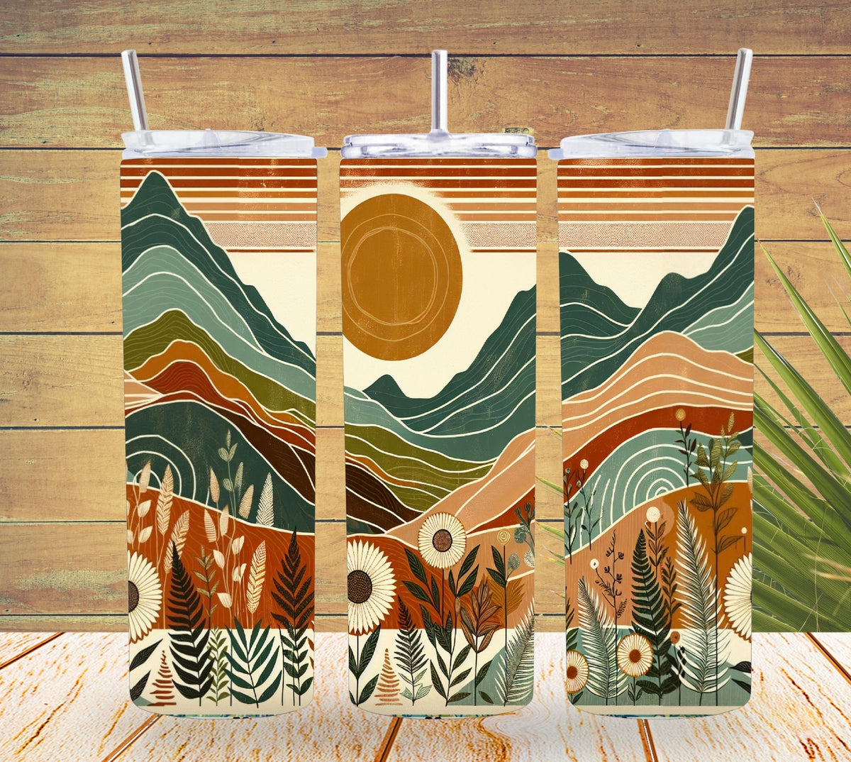 Three tumbler with lids featuring a nature-themed design on a wooden background.