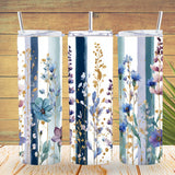 Three floral-patterned tumblers with straws on a wooden surface.