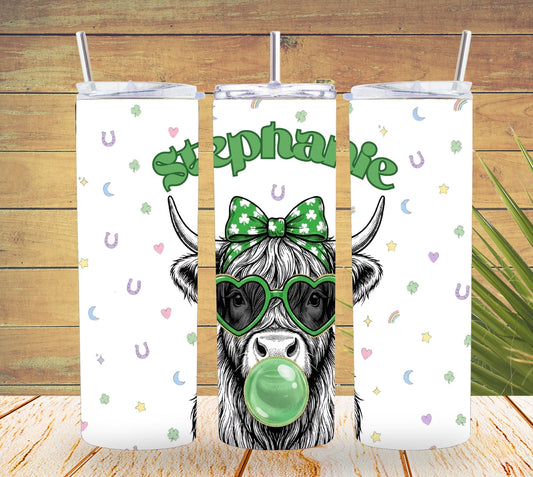 Three tumbler with straw designs featuring a cow with a bow and sunglasses on a wooden background.