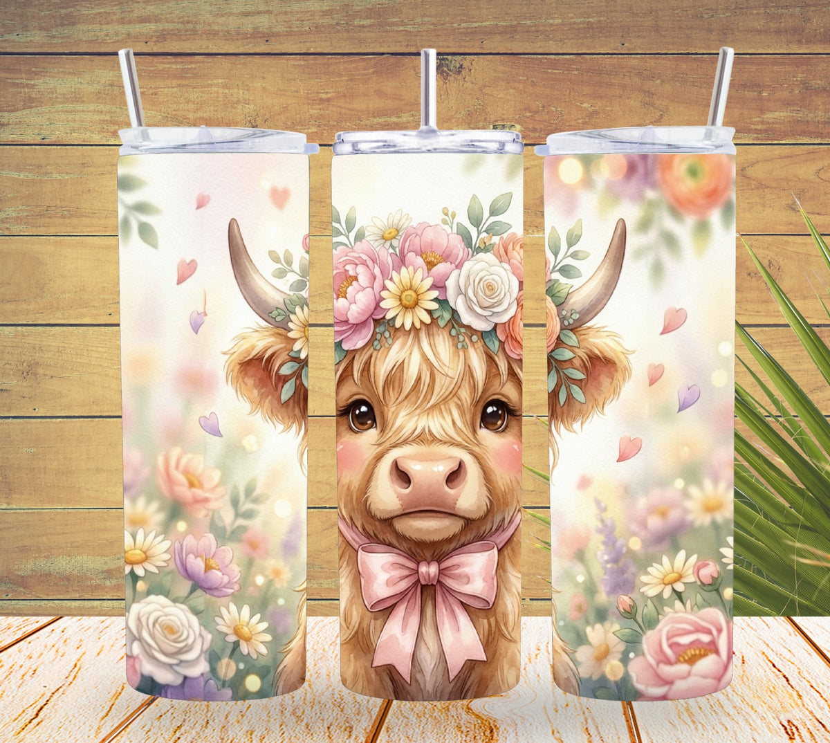 Three tumbler designs featuring a cow with floral decorations on a wooden background.