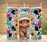 Two colorful tumblers with a cow design and 'Salty Heifer' text on a wooden background.