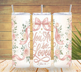 Three tumblers with floral and ribbon design on a wooden background