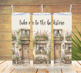 Three tumbler sleeves with a vintage bookstore design on a wooden background.