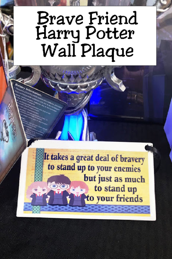 Show your love of Harry Potter with this plaque hanging in your home or office as the perfect Harry Potter gift idea or fandom love.   Plaque has maize yellow background with a green ribbon design down the right side and a blue ribbon design across the bottom. At right corner are graphics of Harry , Ron, and Hermoine.  Wall plaque reads 
