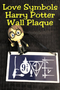 Show your love of the world of Harry Potter and don't hide that love with this fun Harry Potter wall plaque perfect for your home or office.  Plaque has a navy blue background.  Inside border is the world "Love" with fun Harry Potter symbols from the books and movies.  You'll find brooms and wands, the sorting hat, the goblet of fire, the 9 3/4 symbol, the snitch, a lightning bolt, and the Deathly Hollows symbol.